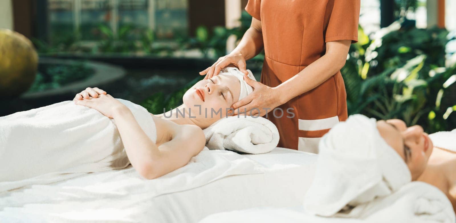 Two caucasian woman having facial massage surrounded by nature. Tranquility. by biancoblue