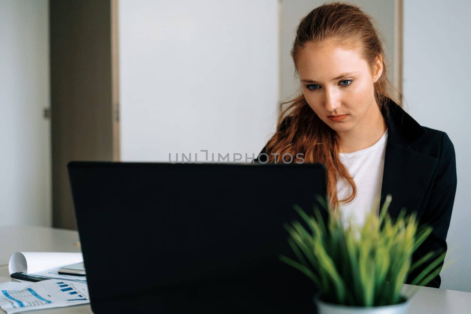 Young businesswoman work using laptop computer at the office desk. Business internet concept. uds