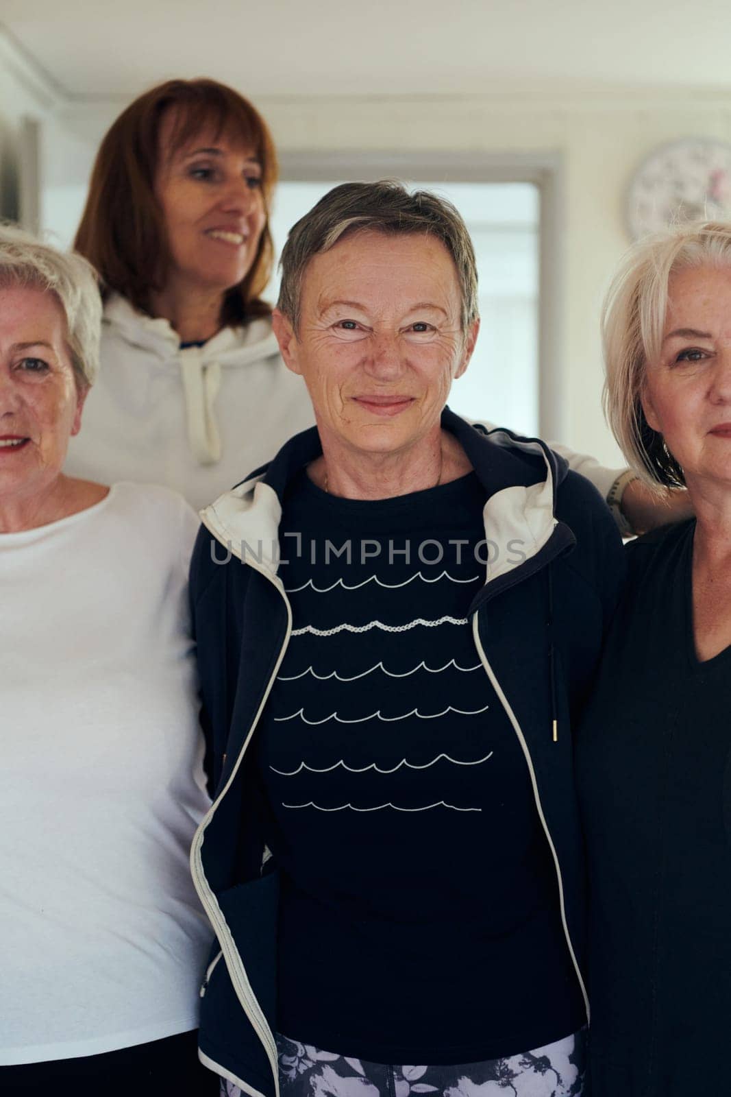 A vibrant community of senior women, guided by their instructor, embraces the enriching journey of yoga, fostering unity, well-being, and a shared commitment to active aging by dotshock