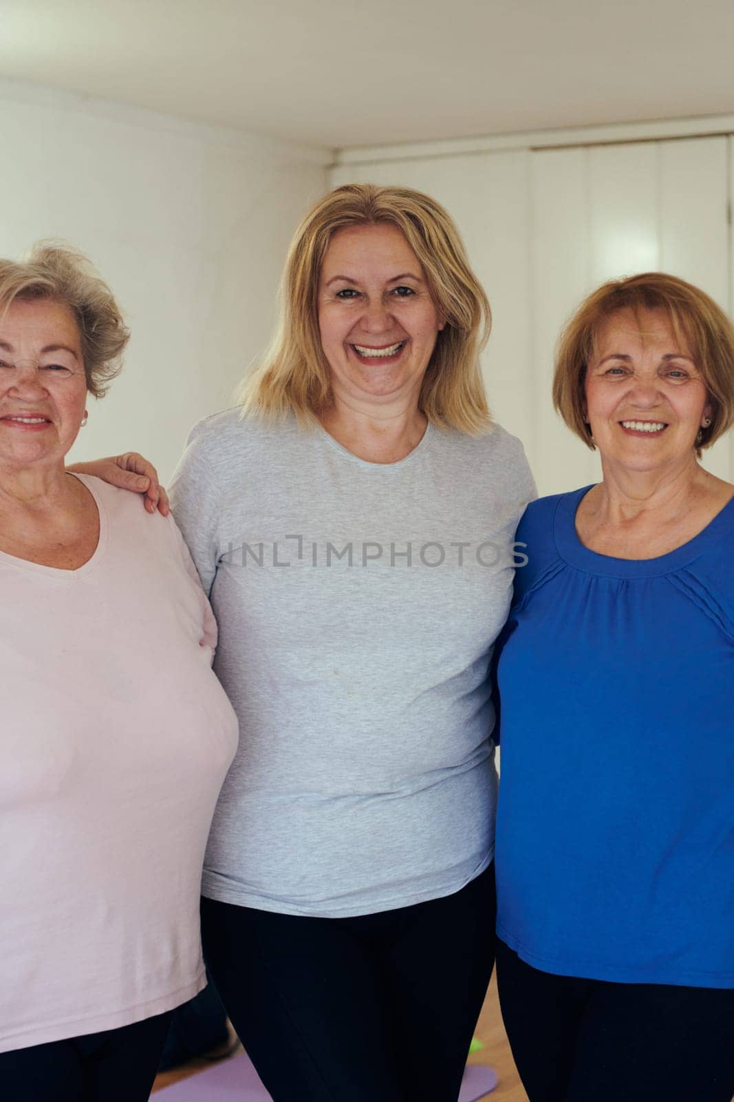 A vibrant community of senior women, guided by their instructor, embraces the enriching journey of yoga, fostering unity, well-being, and a shared commitment to active aging.