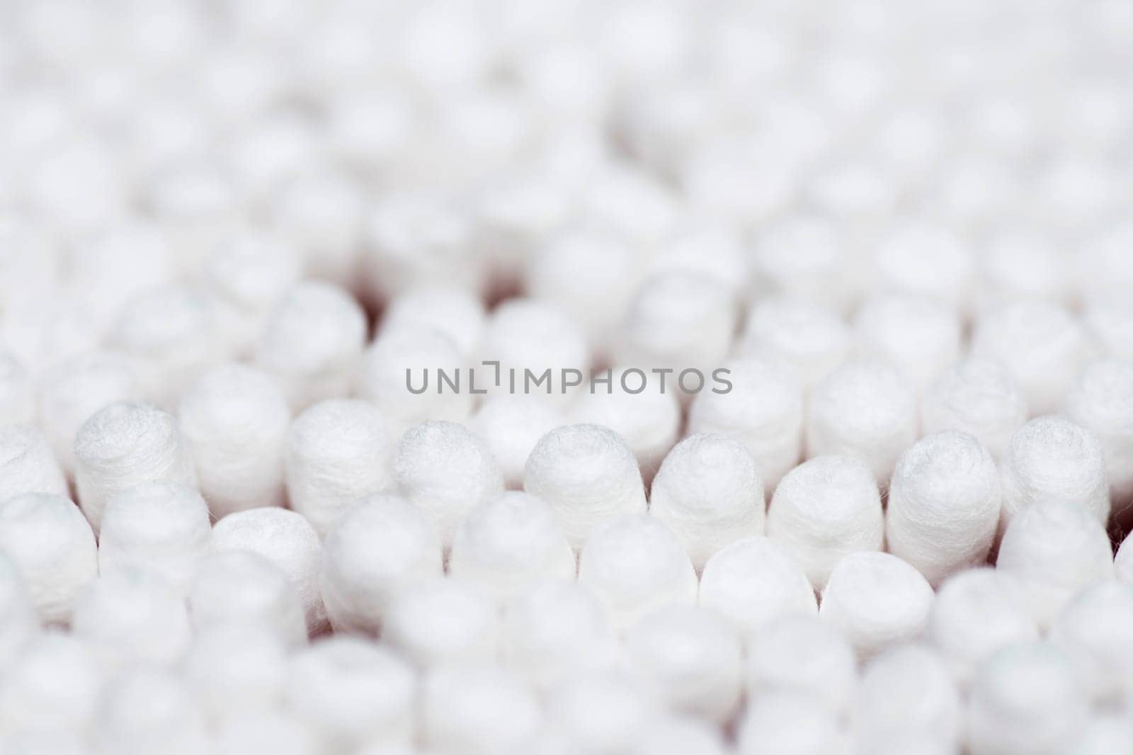 Many white cotton sticks. Round container with cotton buds by andreyz