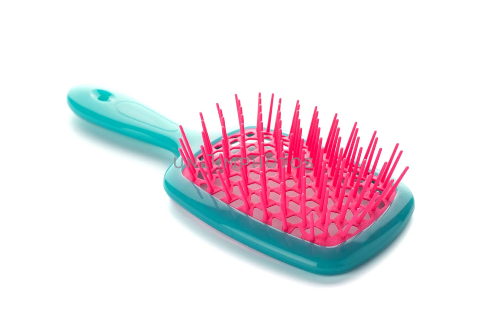 Plastic hairbrush isolated on white background. Colored comb on white background.