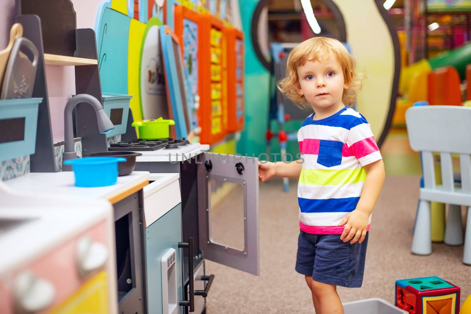 Child playing with colorful toys at the learning center or in kindergarten by andreyz