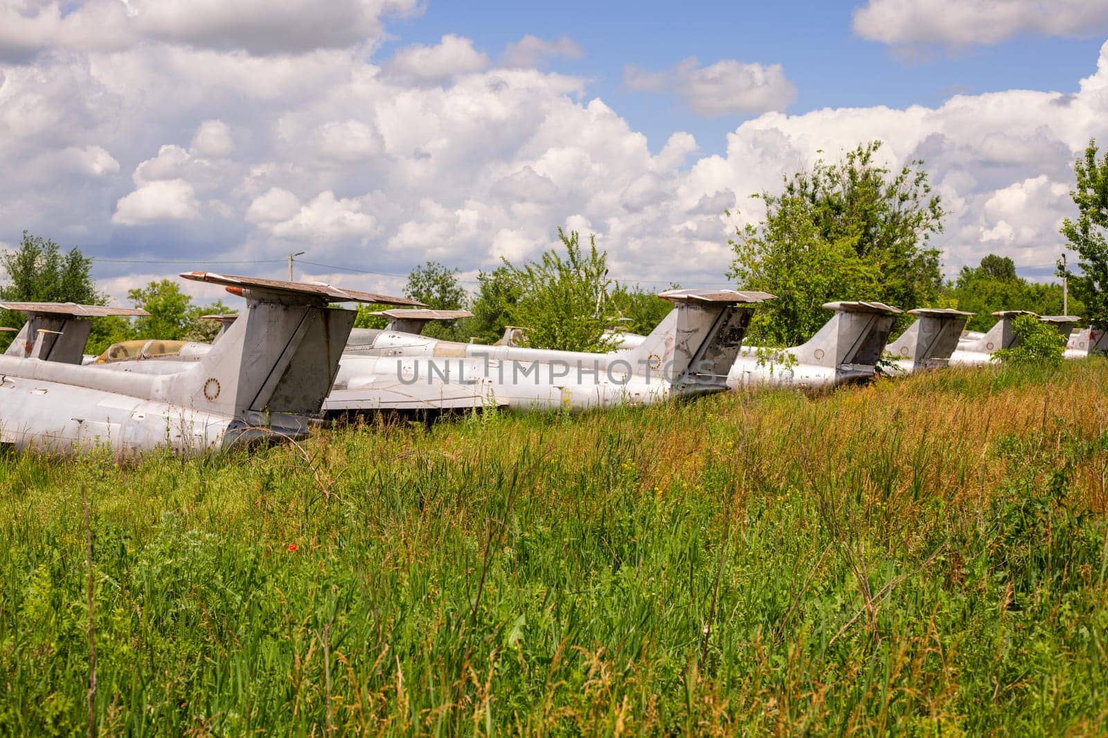 Old abandoned airfield with abandoned planes. Abandoned rusty old planes on the grass