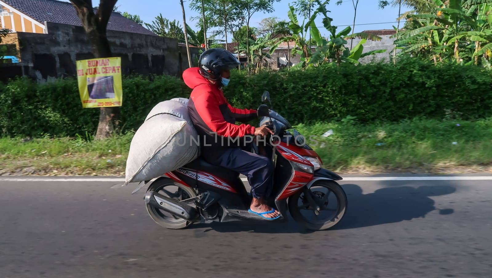 motorbike riding in asia as one of goods transportation method, being used to transport many kind of goods intercity by antoksena