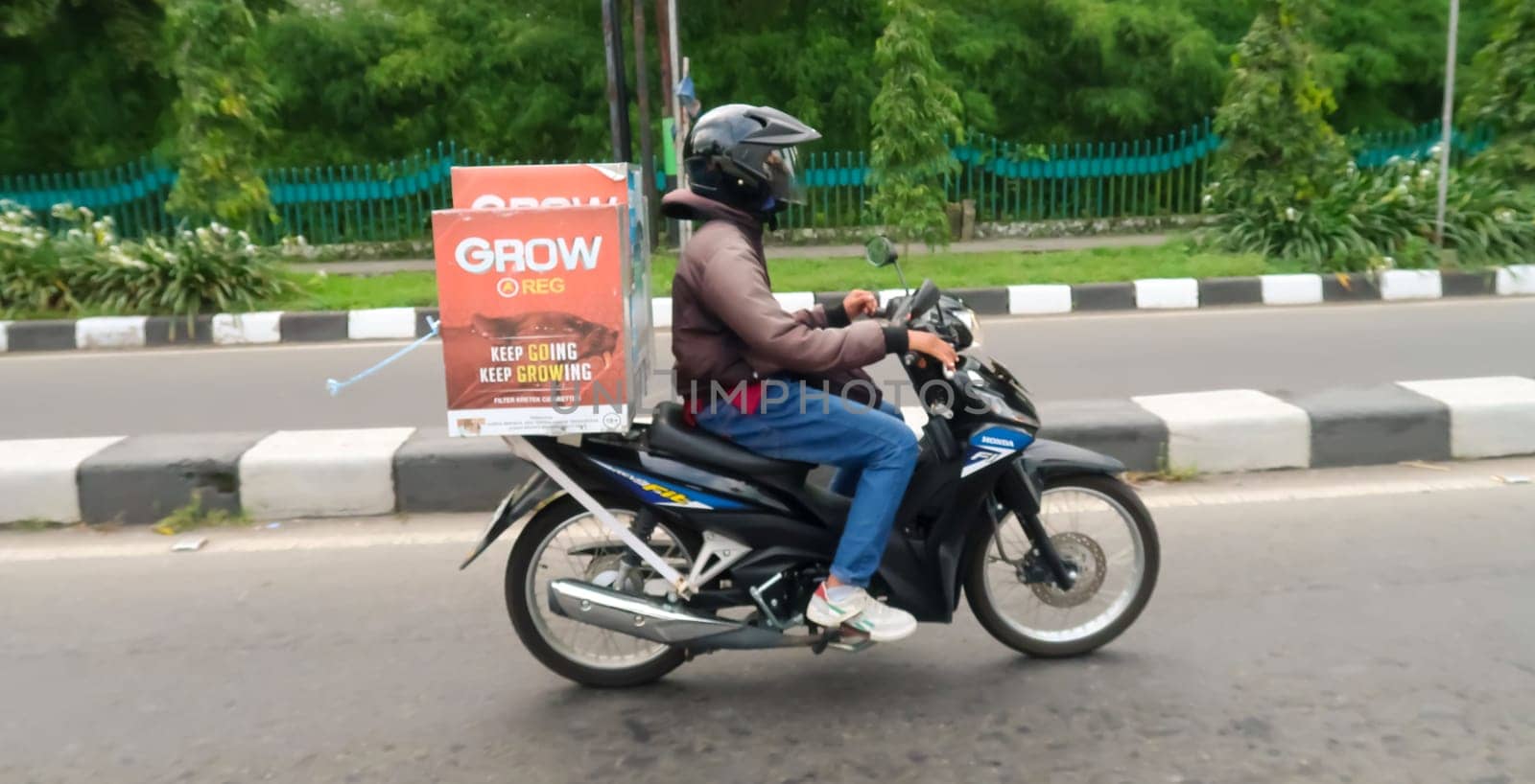 motorbike riding in asia as one of goods transportation method, being used to transport many kind of goods intercity in central java indonesia