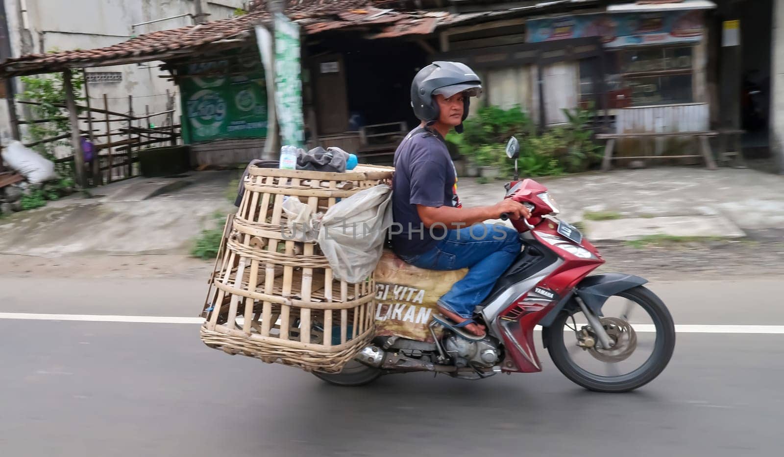 motorbike riding in asia as one of goods transportation method, being used to transport many kind of goods intercity by antoksena