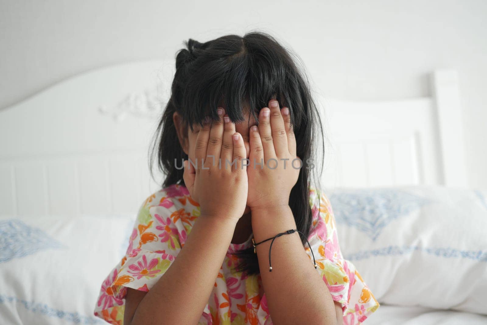 a upset child girl cover her face with hand by towfiq007