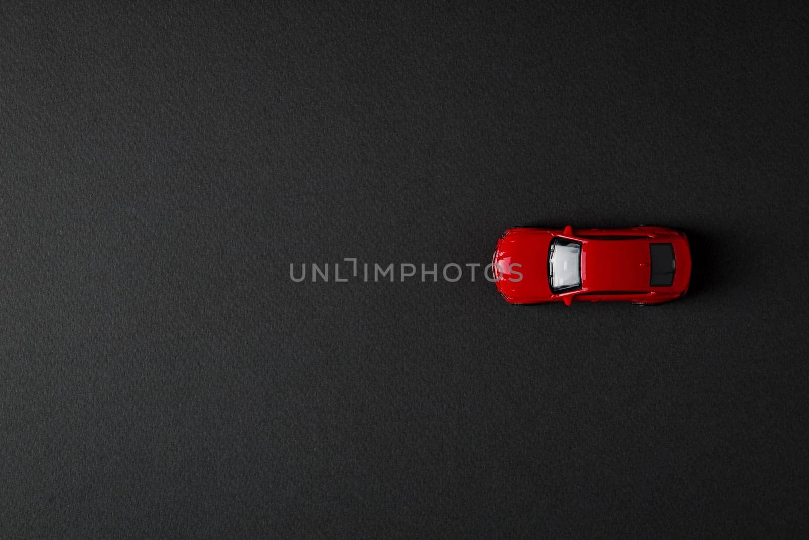 top view of toy red car on dark background