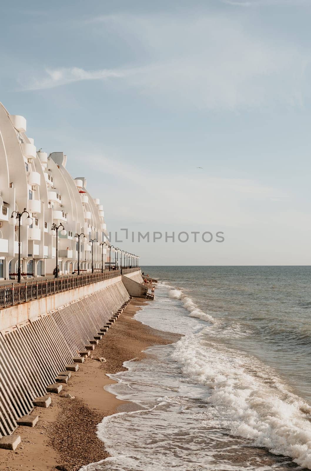 Coastal residential areas with a modern hotel and restaurant complex alongside sandy beaches. Summer holiday vacation and travel concept. by panophotograph