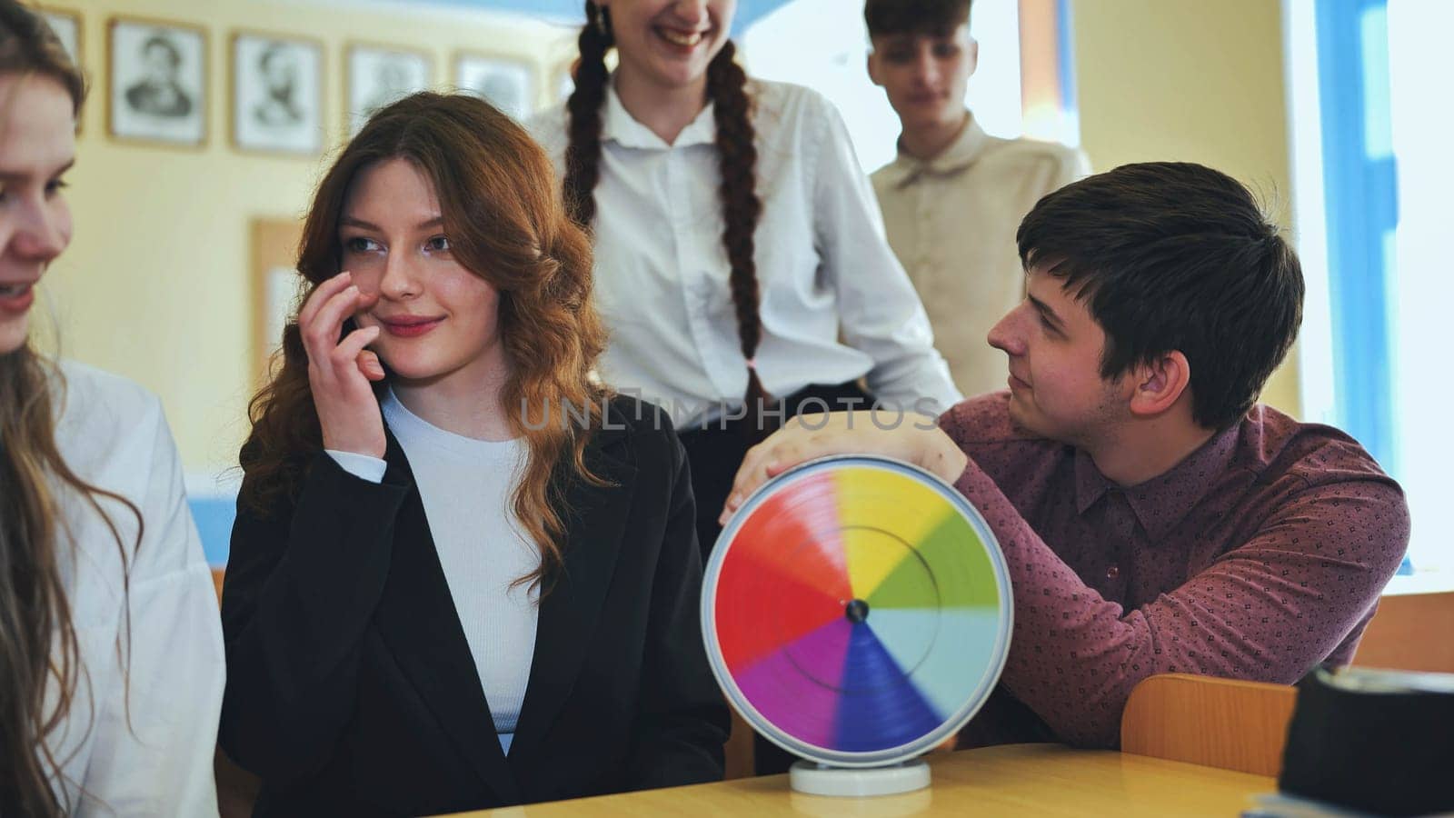 Students in physics class spin Newton's colorful wheel