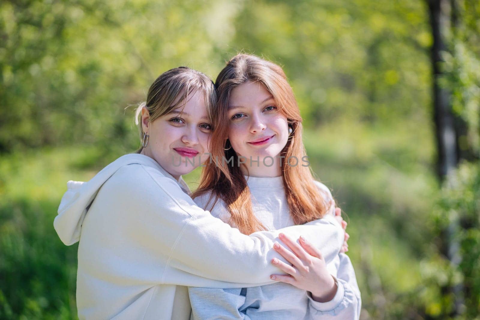 Portrait of two high school girls against the backdrop of the school