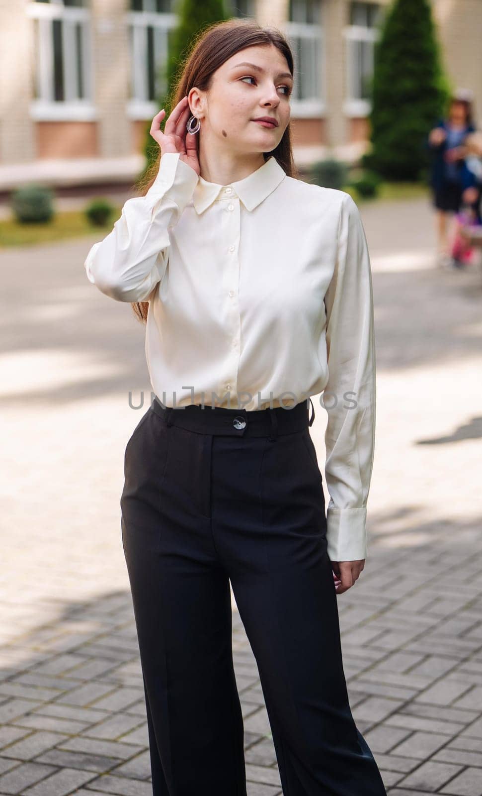 Portrait of a high school student against the backdrop of the school. by DovidPro