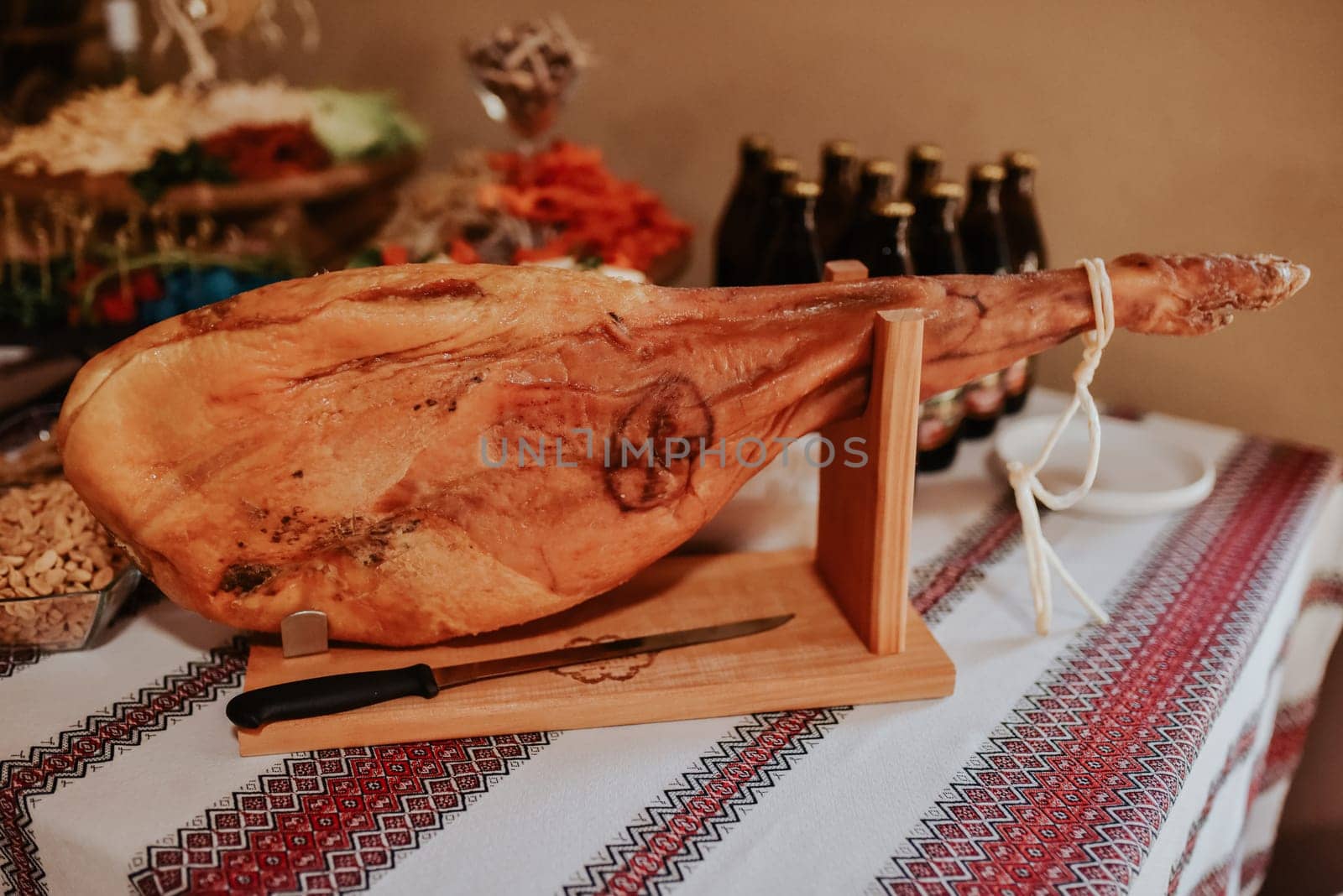 Spanish ham, Jamon Serrano, Bellota Italian.Prosciutto Crudo or Parma ham, whole leg. Italy, food. a large piece of Italian.Parma ham hanging from a hook. prosciutto leg hangs on table in display case