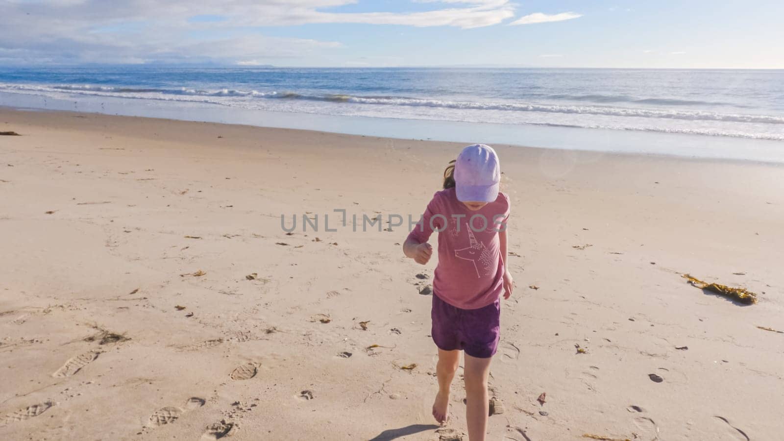 Little Girl Plays on Empty California Beach by arinahabich