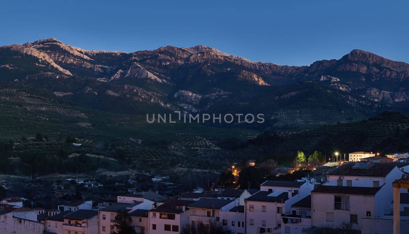 Sierra de Cazorla. Quesada Andalusia Spain. Beautiful mountains at evening and white buildings on the foreground. by artgf