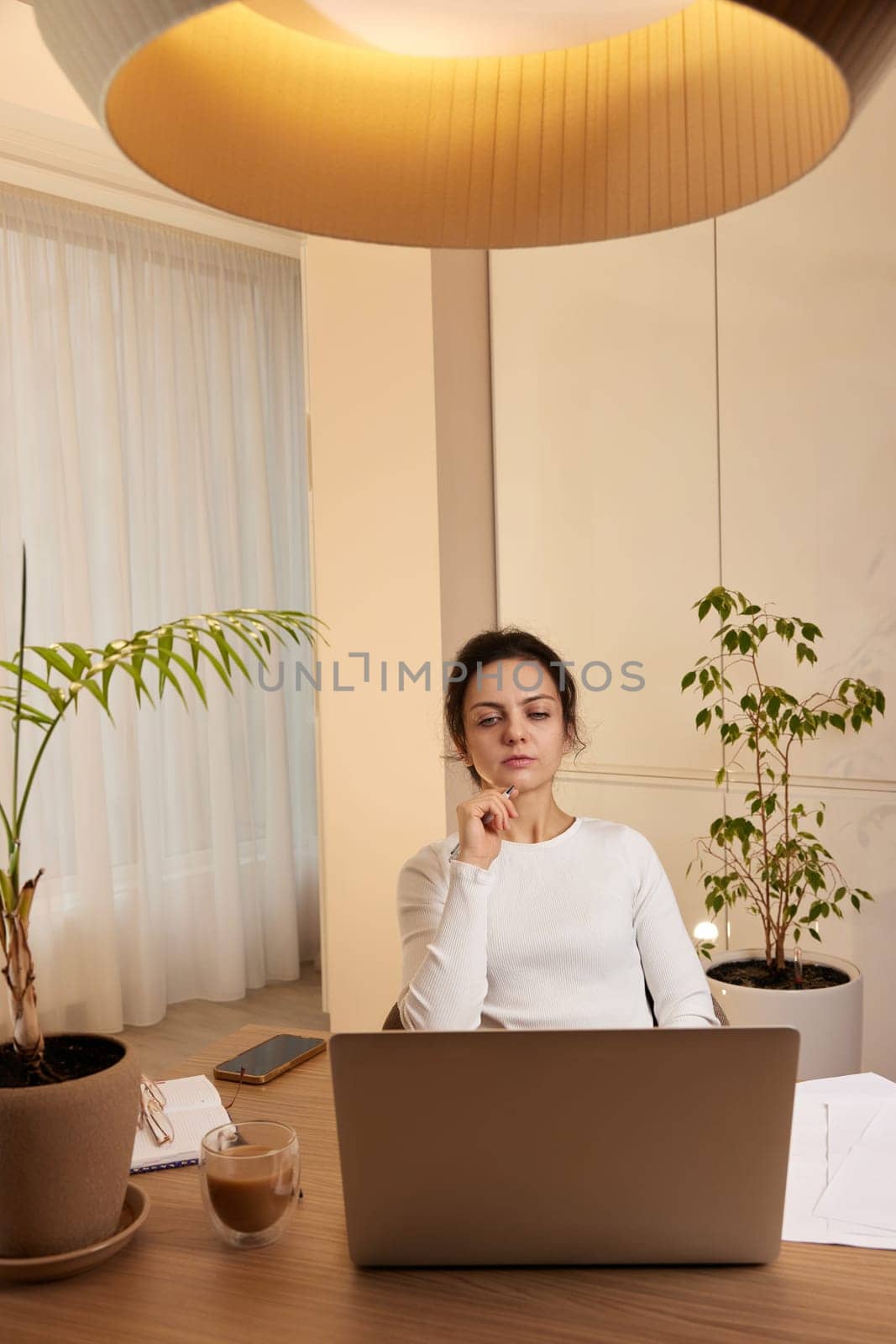 beautiful businesswoman using laptop and communicates with customer on internet at home