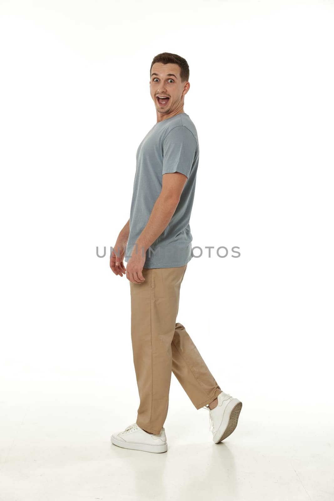 surprised guy looking at camera on white studio background