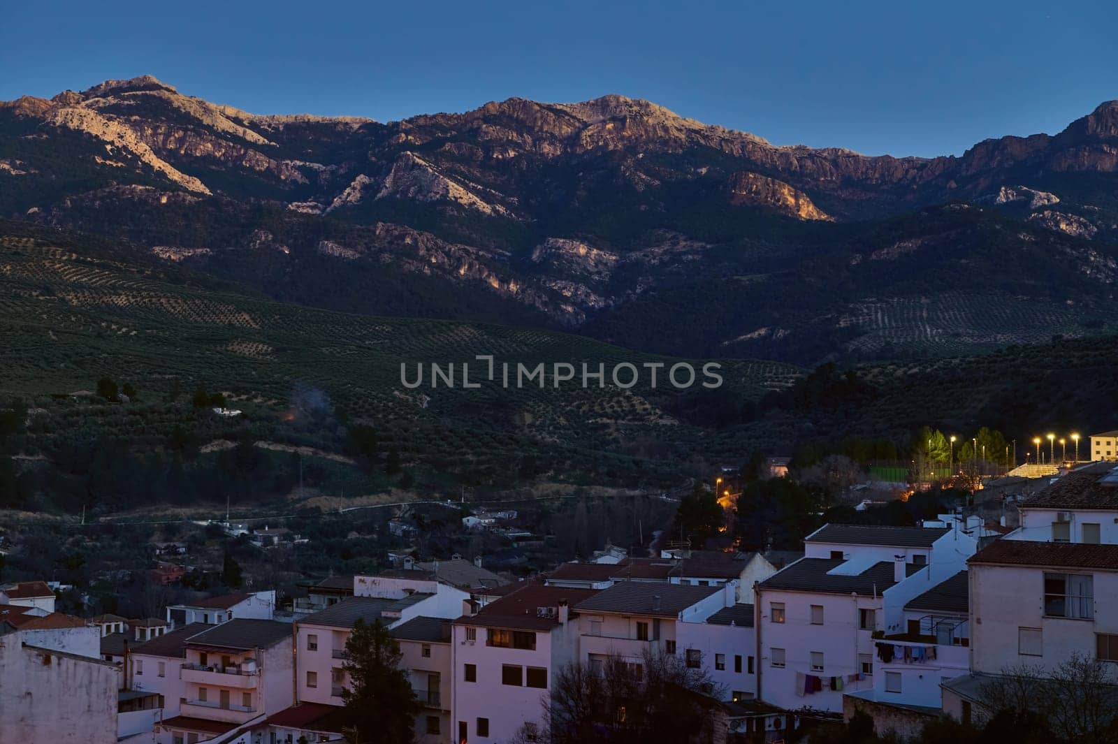 View of a famous beautiful medieval and historic Spanish city Quesada in province of Jaen in Andalusia, illuminated with street lights in the night time. Lifestyle, Travel and tourism concept.