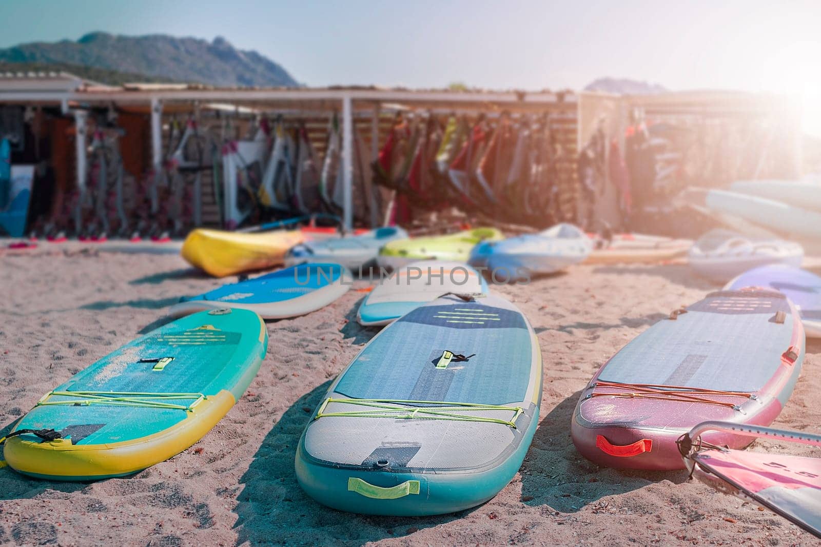 Windsurf boards on the sand at the beach. Windsurfing and active lifestyle. Sardinia