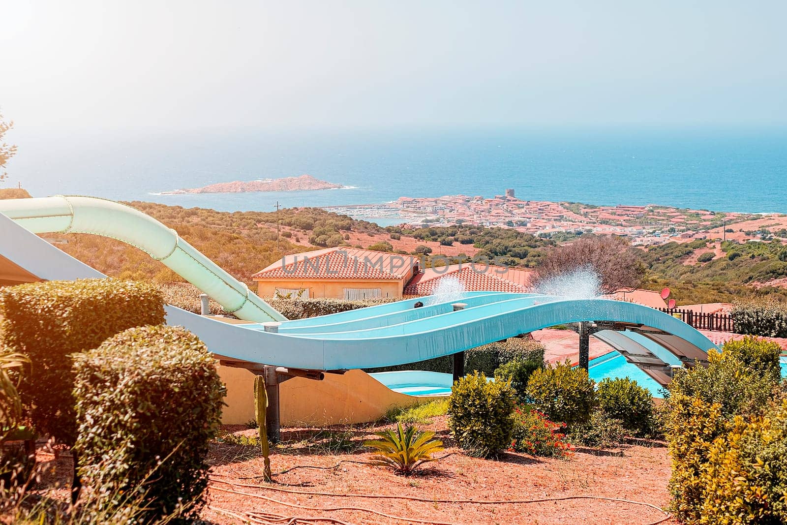 Grand slide in water park with a view of the blue sea in Sardinia, Italy