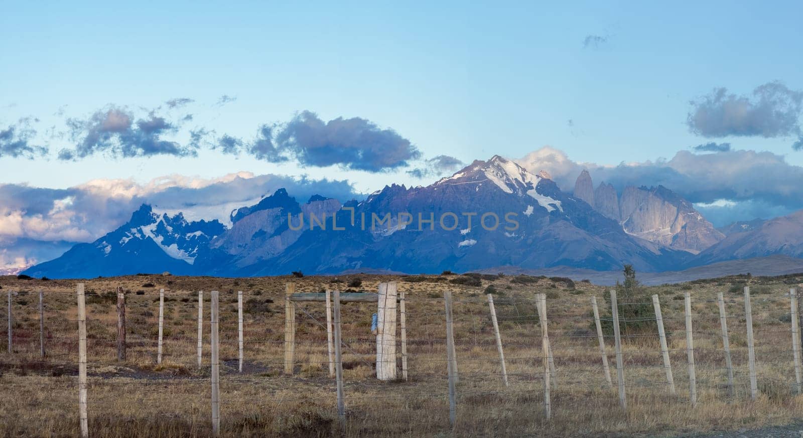Majestic Mountain Ranges Behind Rustic Wooden Fence by FerradalFCG
