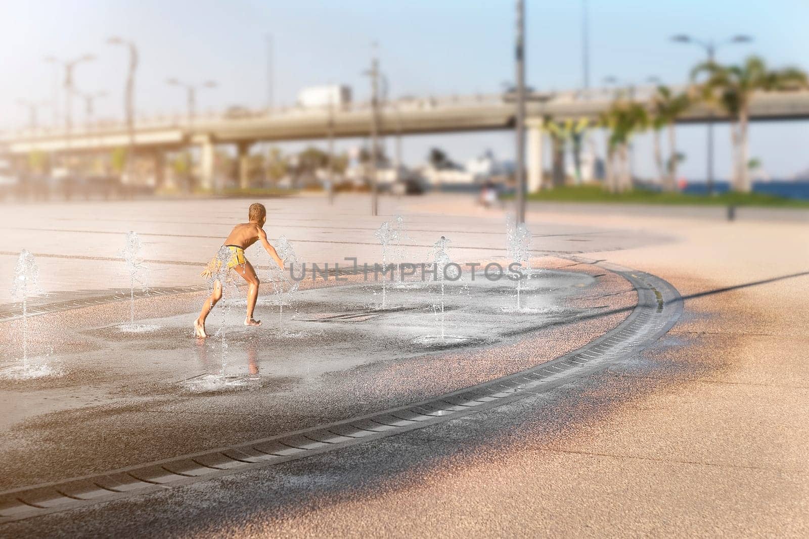 Children in the city in summer in abnormally hot weather splash and have fun in the stone fountain. Boy play and run in spray of water