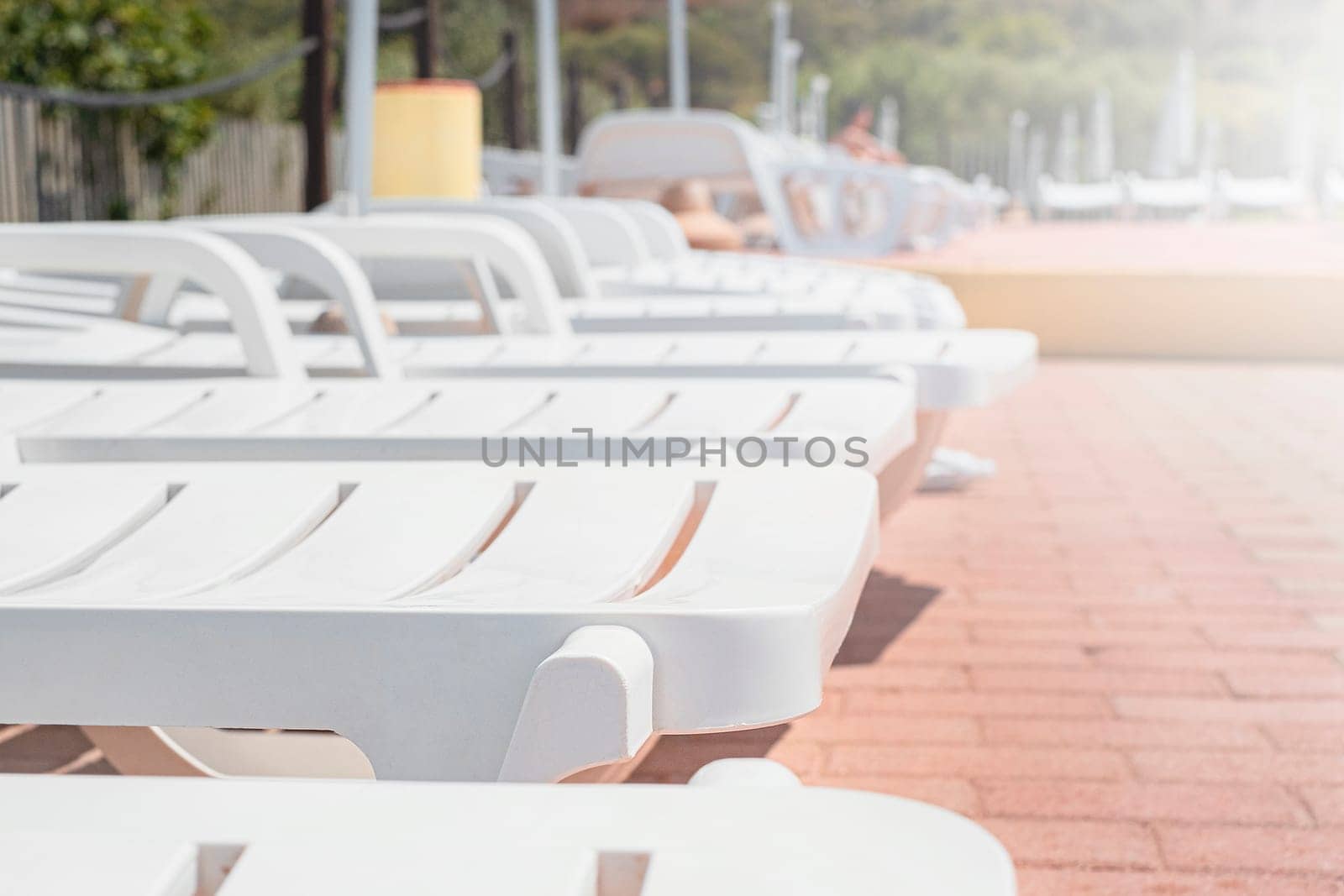 Empty sunbeds by the relax resort pool.
