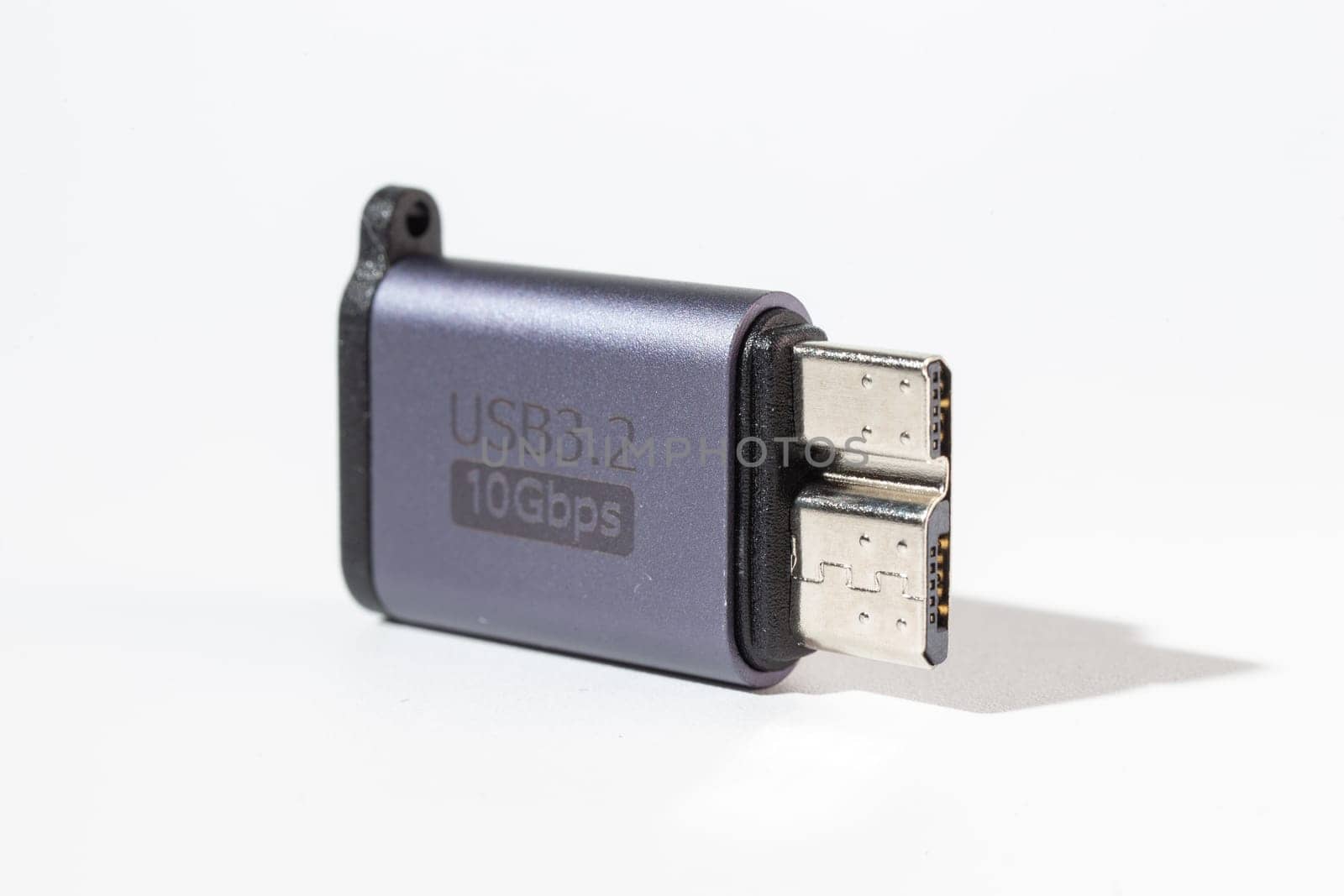 Isolated dark gray USB With HDD adapter on a white background. by Pukhovskiy