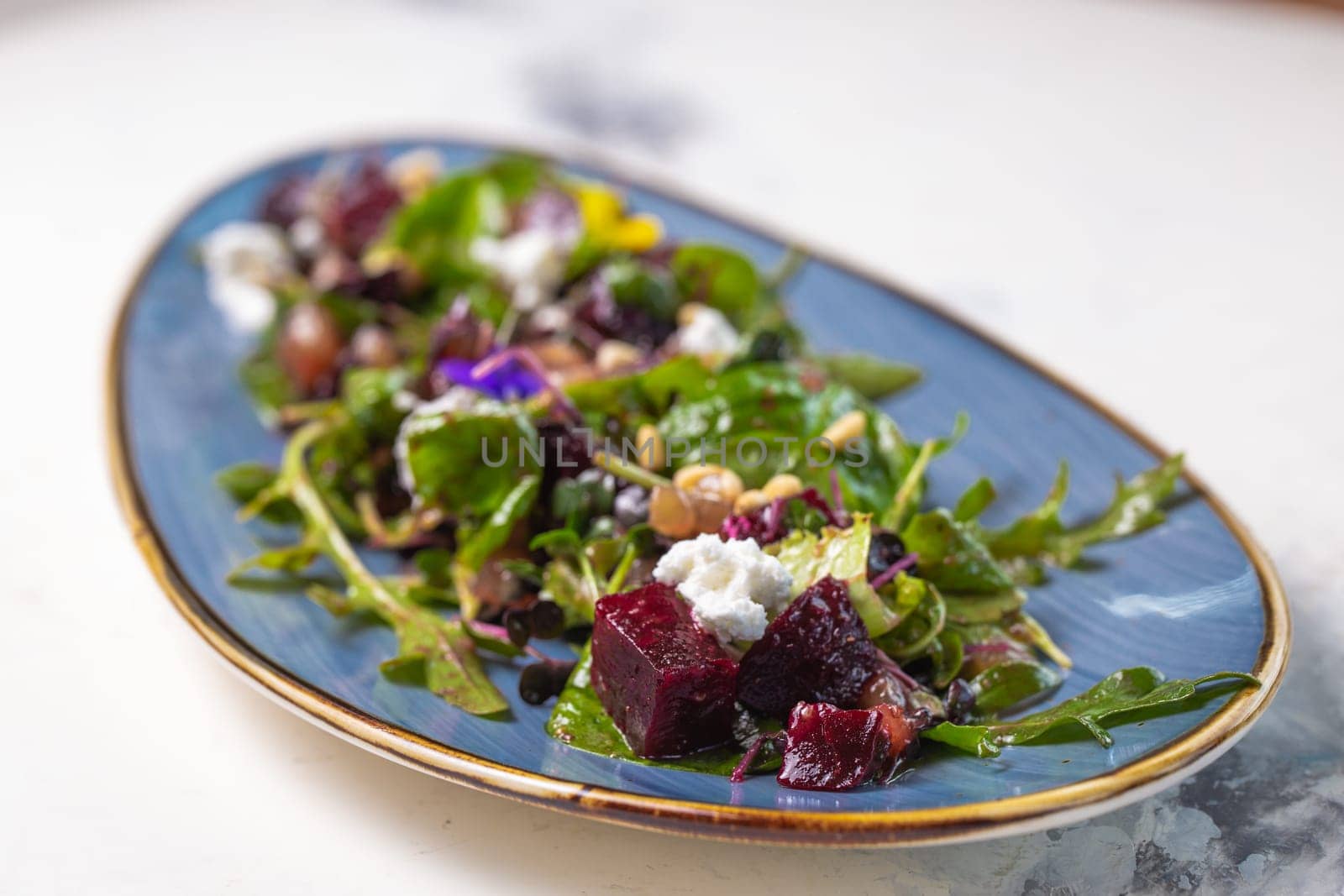 Organic baby greens salad with beets, goat cheese, pistachios, citrus dressing by Pukhovskiy