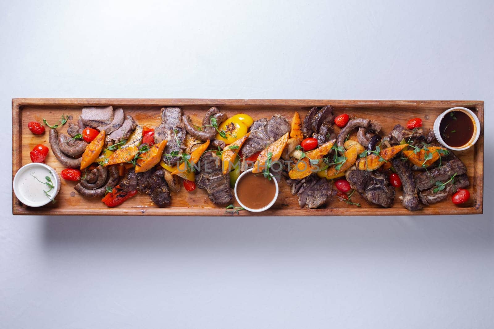 Top view Rustic wooden platter with assorted meats and vegetables by Pukhovskiy