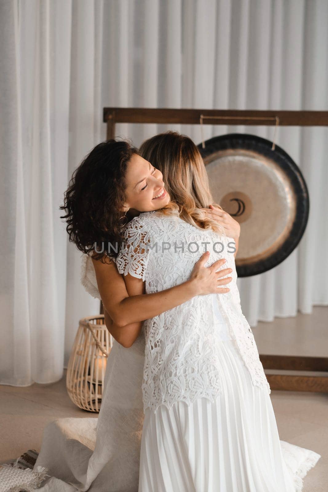 Two women hug at yoga. Women's Circle by Lobachad