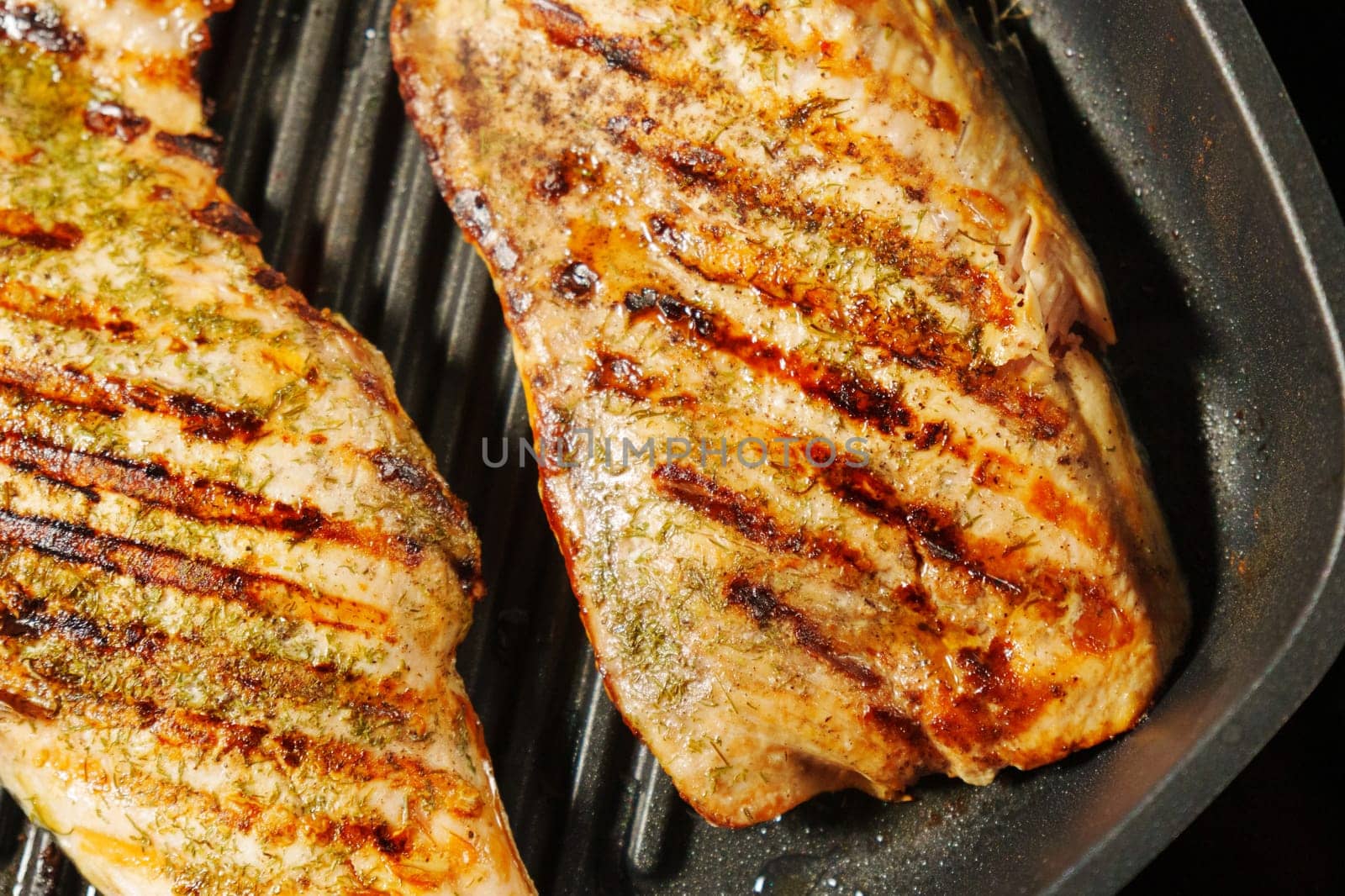 Salmon fillets sizzle and cook to perfection on a grill, infusing the air with a tantalizing aroma by darksoul72