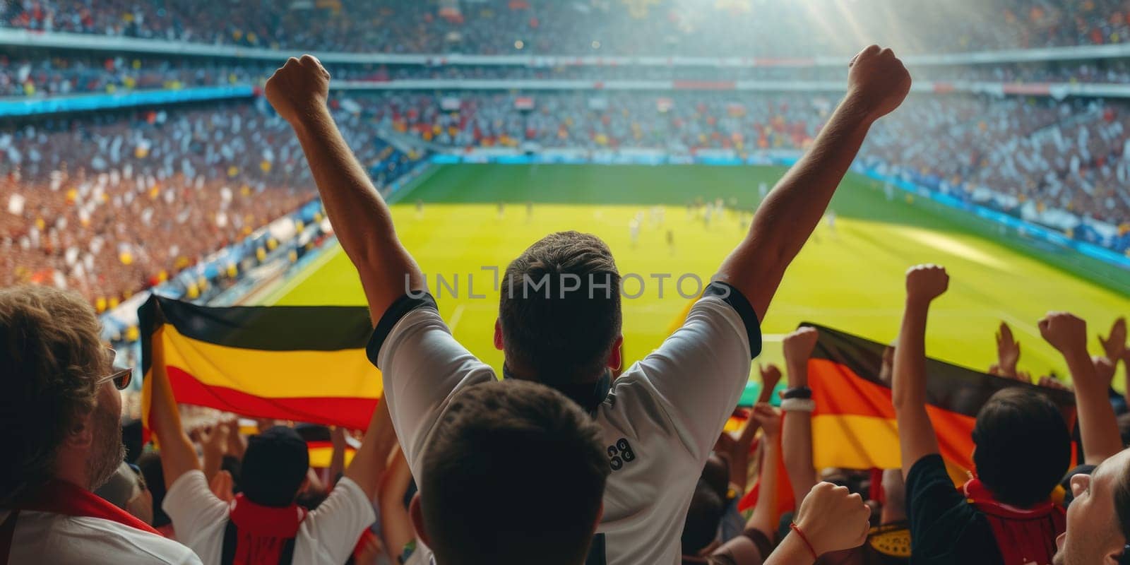 A fan at a world competition event raises his arms in the air, enjoying the fun and energy of the crowded stadium. AIG41