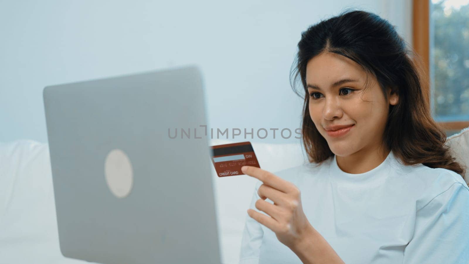 Woman shopping or pay online on internet marketplace browsing for sale items for modern lifestyle and use credit card for online payment from wallet protected by vivancy cyber security software