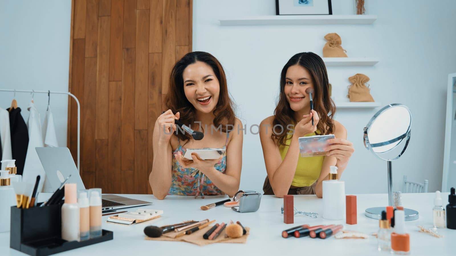 Two influencer partner shoot live streaming vlog video review makeup social media or blog. Happy young girl with vivancy cosmetics studio lighting for marketing recording session broadcasting online.