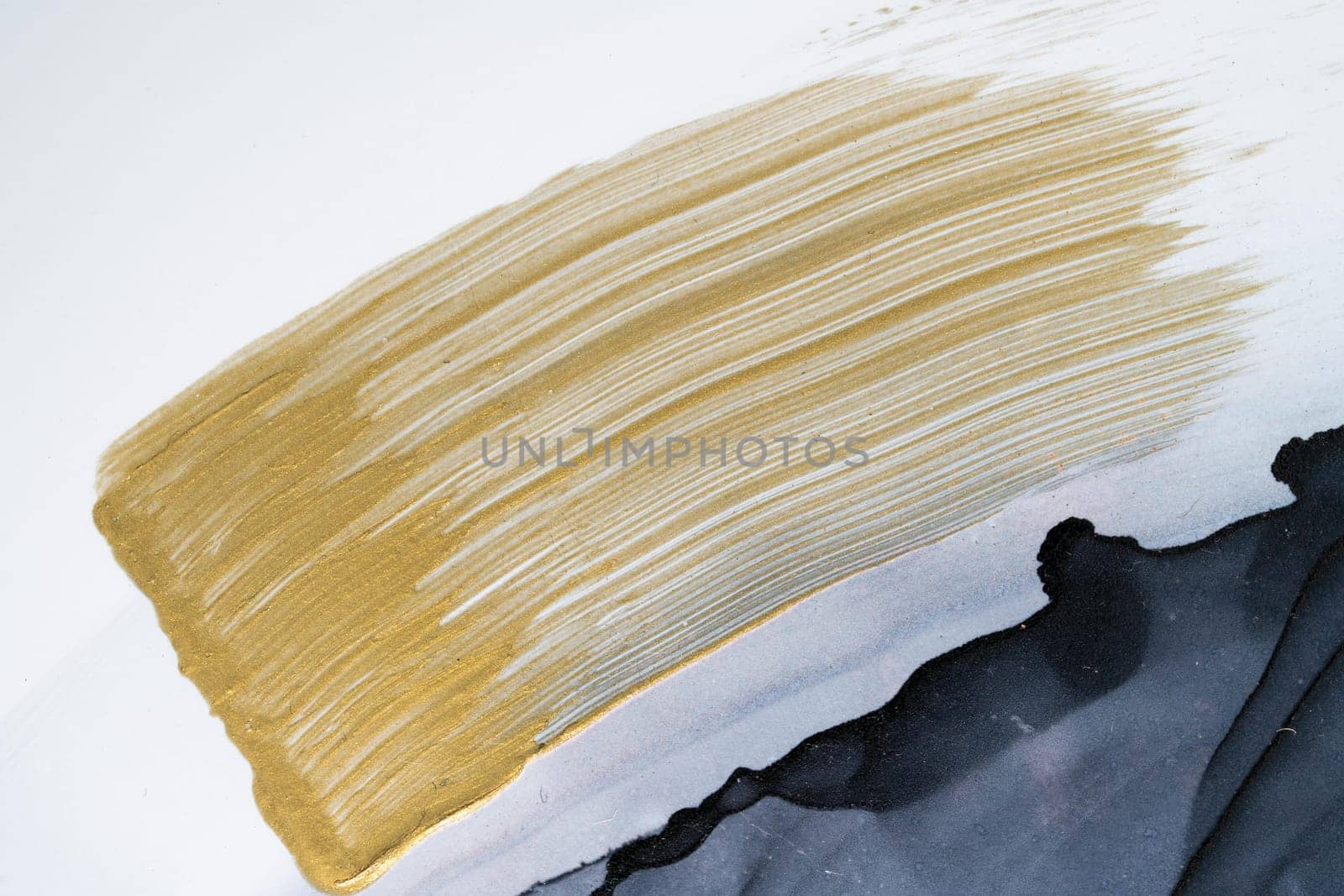 Hand drawn brush stroke gold paint stain texture on paper. by biancoblue