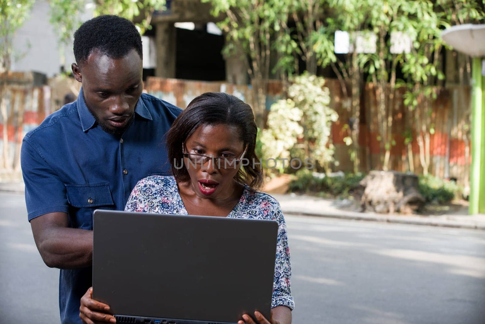 portrait of a young couple with laptop. by vystek