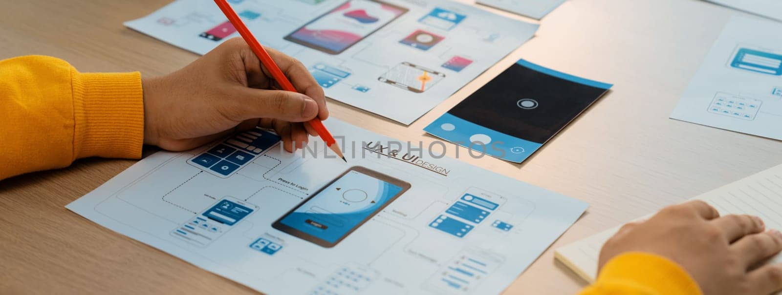 Panorama banner of startup company employee planning on user interface prototype for mobile application or website in office. UX UI designer brainstorm user friendly interface plan. Synergic