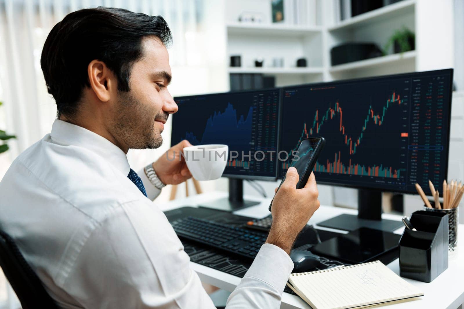 Trader businessman holding coffee cup focusing on dynamic on phone, stock exchange investment screen comparing data analysis to invest high profit financial technology market at home office. Surmise.