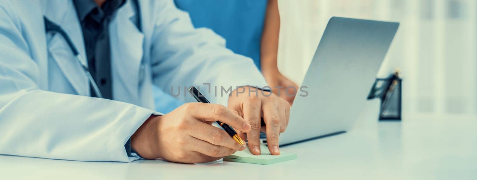 Professional various team of medical working and planning medical treatment at hospital table together. Teamwork lead to successful illness and sickness treatment. Panorama Rigid