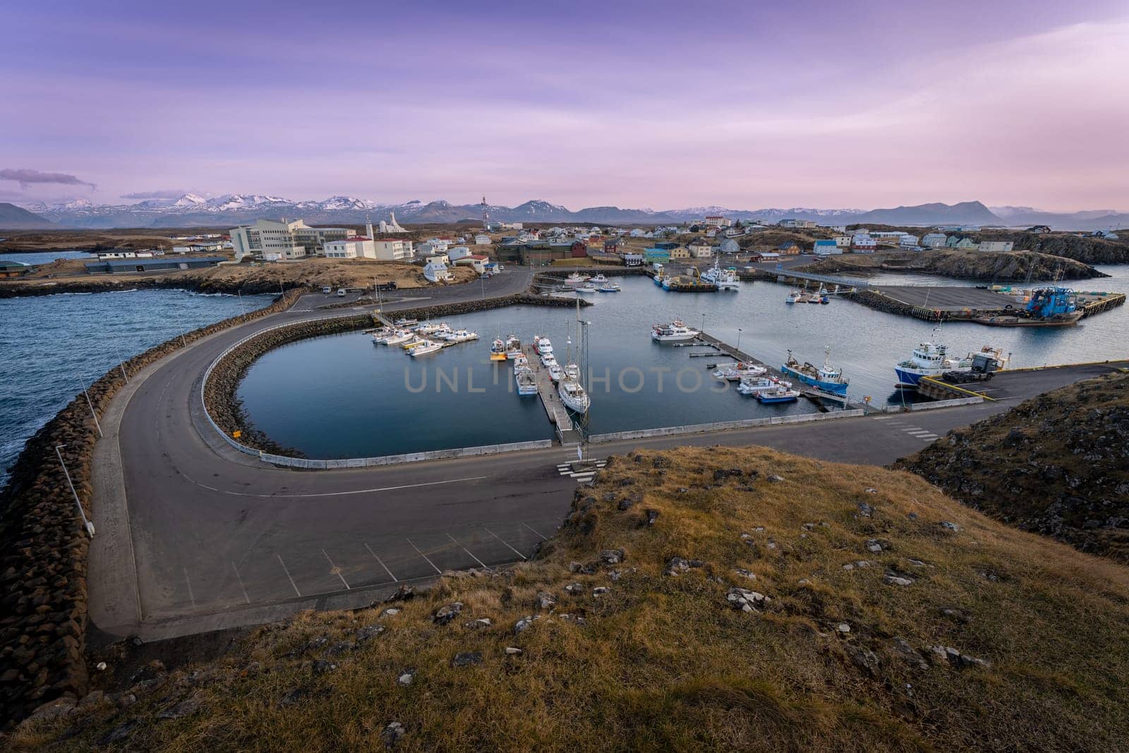 Stykkisholmur from Sugandisey lighthouse at sunset cliff by LopezPastor