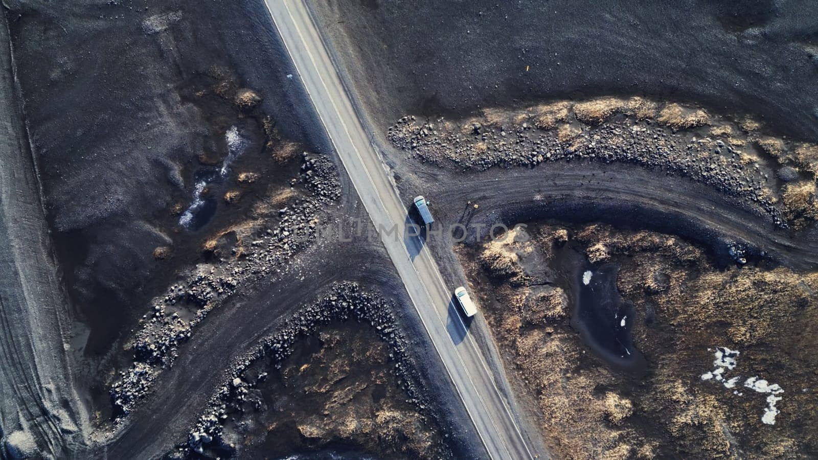 Arctic landscape in iceland, beautiful icelandic fields and roads in countryside. Natural frozen black lands with snow forming scandinavian scenery. Drone shot. Aerial view.