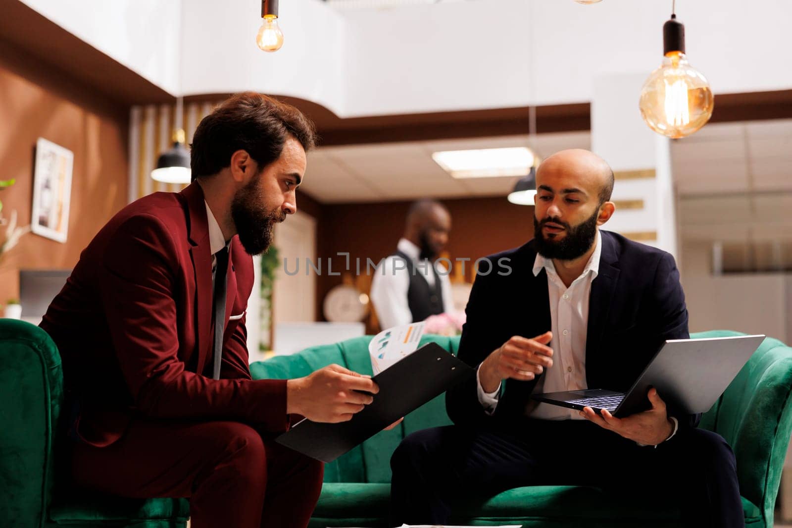 Business professionals gather at hotel for international conference, united by their shared passion for global economic growth. Employee travelling on business trip to meet partner.