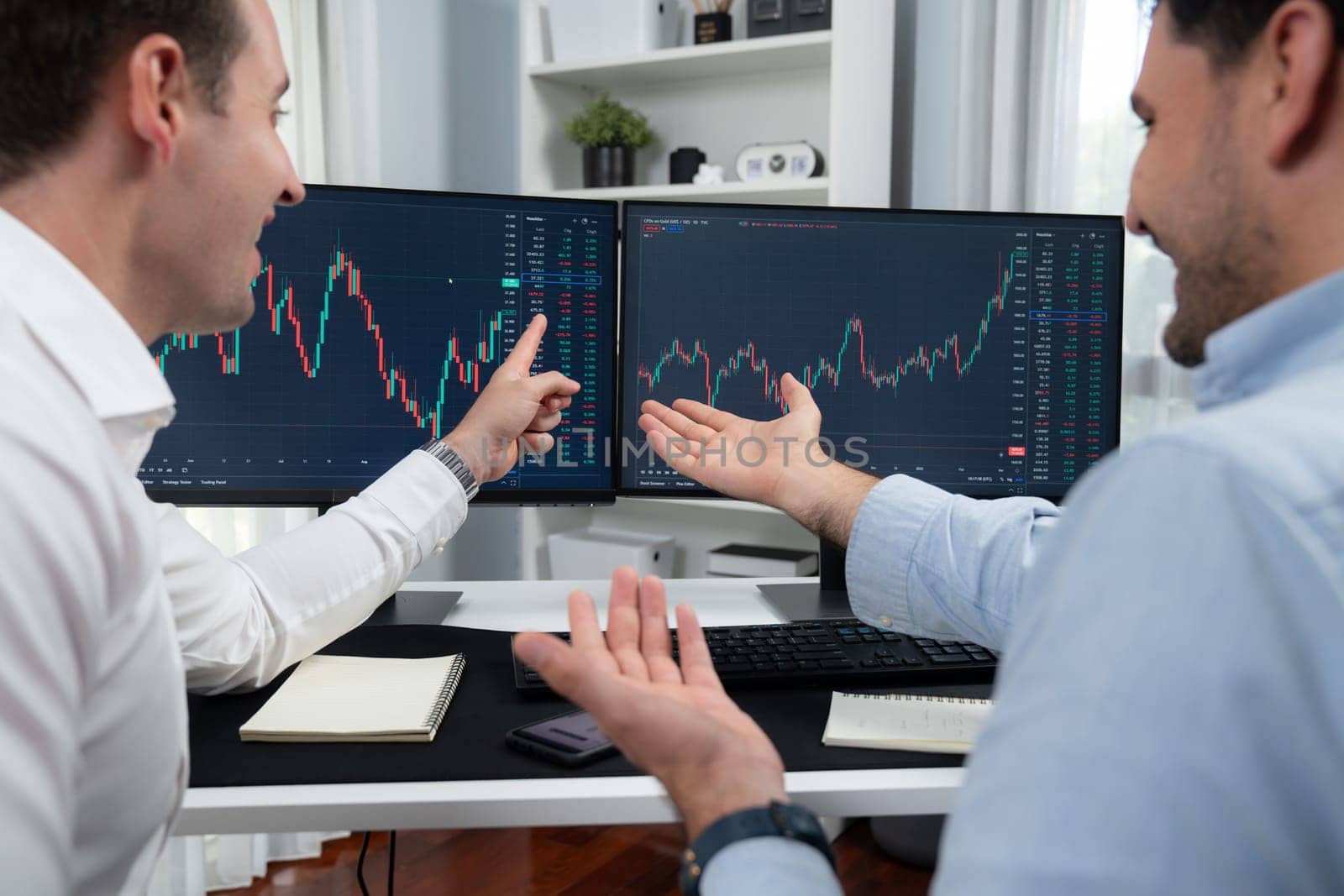 Successful stock exchange traders focusing on high profit chart investment on dynamic database, analyzing on monitor. Concept of discussing financial technology growth at workplace. Sellable.