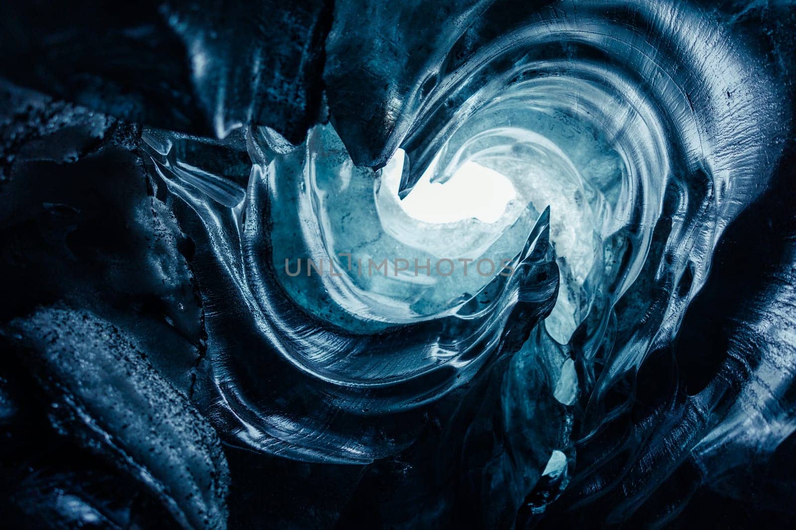 Impressive ice structures, big blue frozen rocks of frigid structure in Vatnajokull caves. Ice tunnels in arctic region wiped out due to climate change, frosty transparent glaciers.