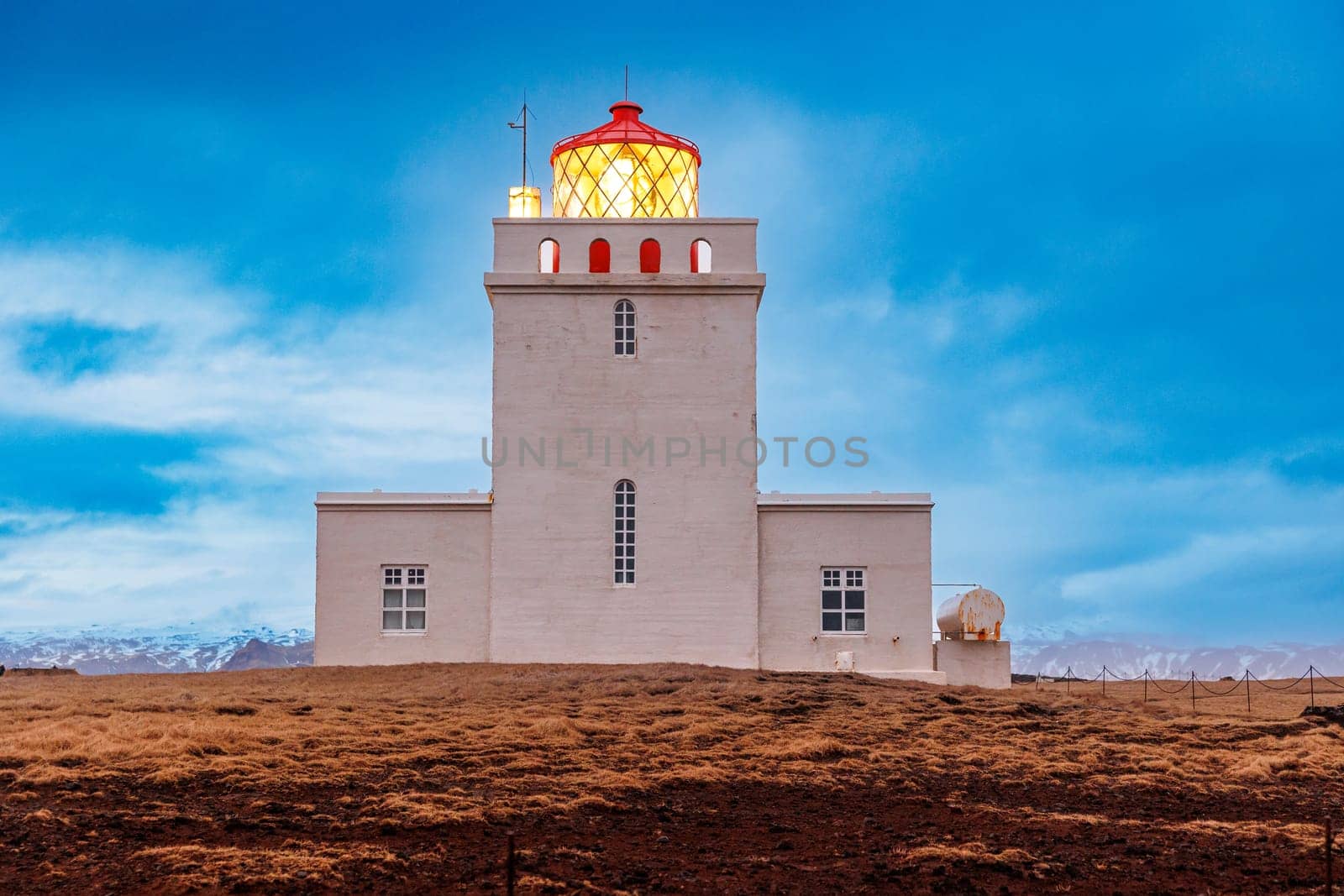 Dyrholaey lighthouse on peninsula by DCStudio