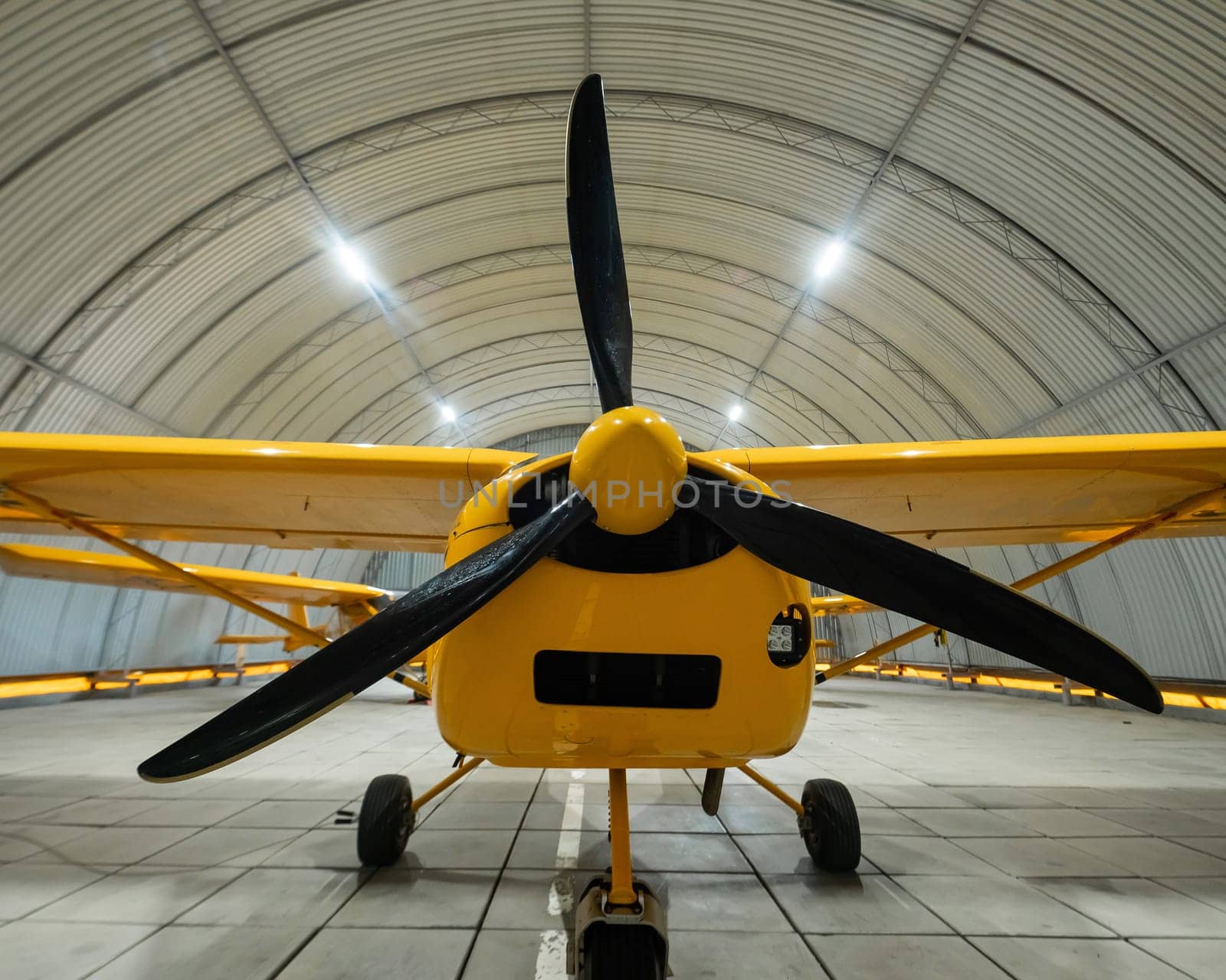 Yellow airplane glider in the hangar. by mrwed54