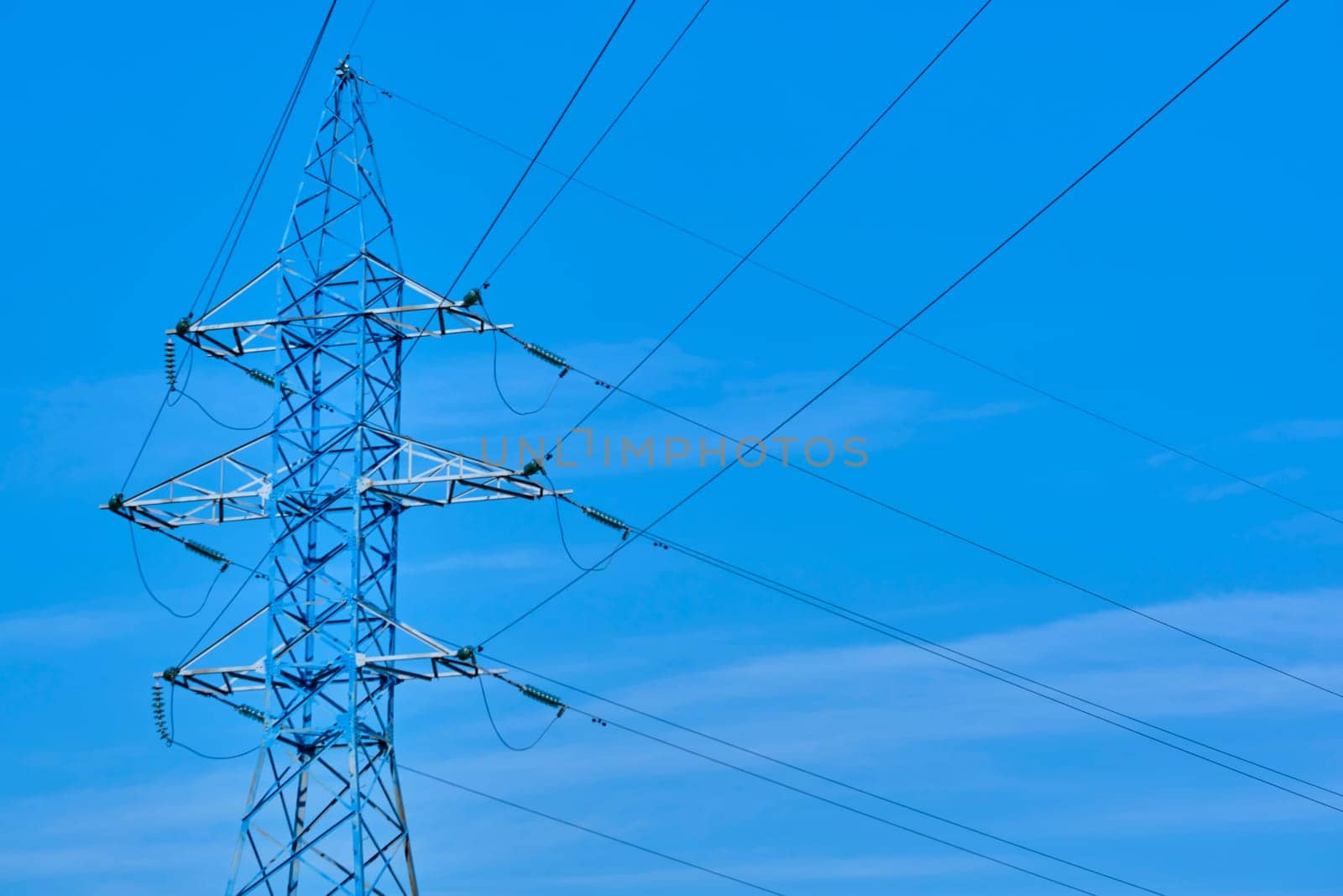 line of power lines against the blue sky color by lempro