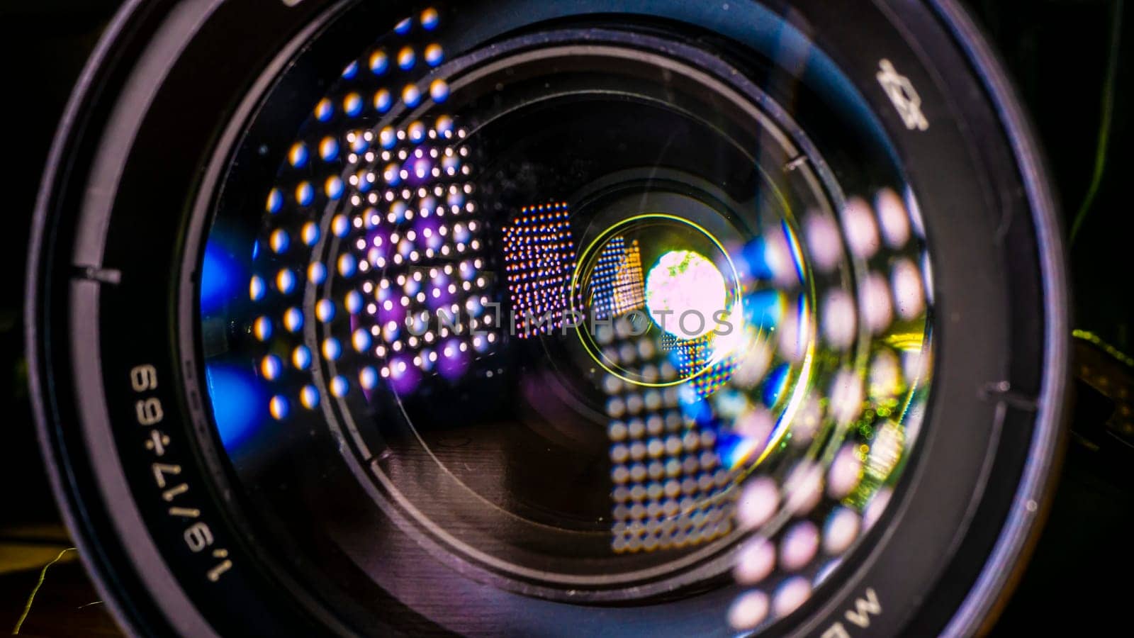 Close up dust and peel on a camera lens background. Macro view. color lights by lempro